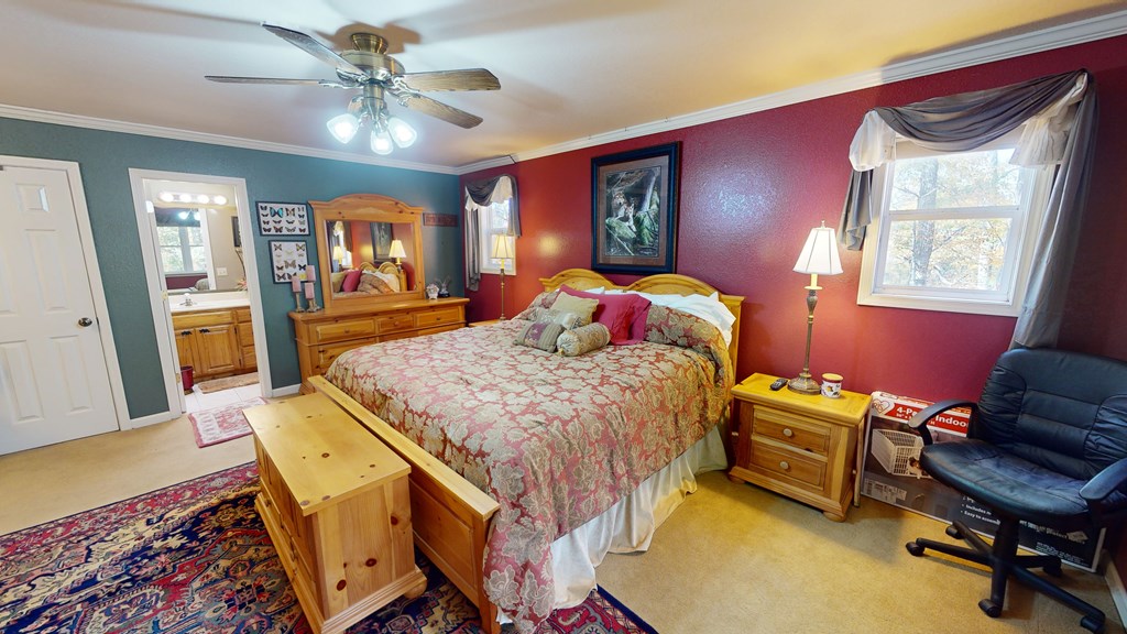 52 Bear Track Road Andrews, NC 28901 - Photo 23 of 38 a bedroom with a bed a desk and chair with wooden floor