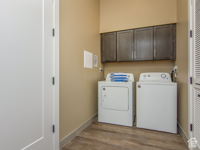 2331 Mesa Road, Unit E3 Moab, UT 84532 - Photo 32 of 71 Laundry area featuring wood finished floors, cabinet space, and washing machine and clothes dryer