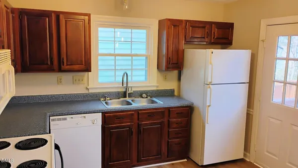 a kitchen with a refrigerator and a sink