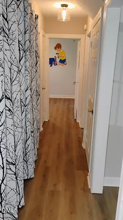 a bedroom with baby bed toys and wooden floor