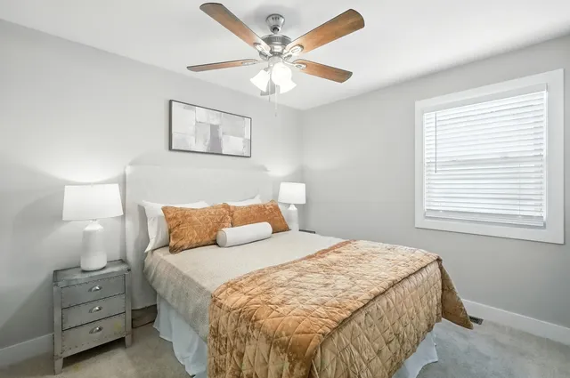a bedroom with a bed and a lamp