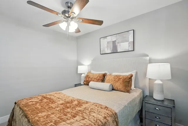 a bedroom with a bed and a painting on the wall