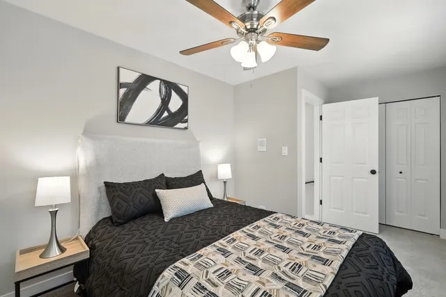 a bedroom with a bed and a chandelier