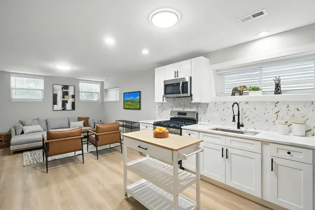 a kitchen with a stove a sink and a refrigerator