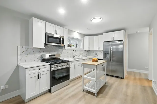 a kitchen with a sink stove and refrigerator