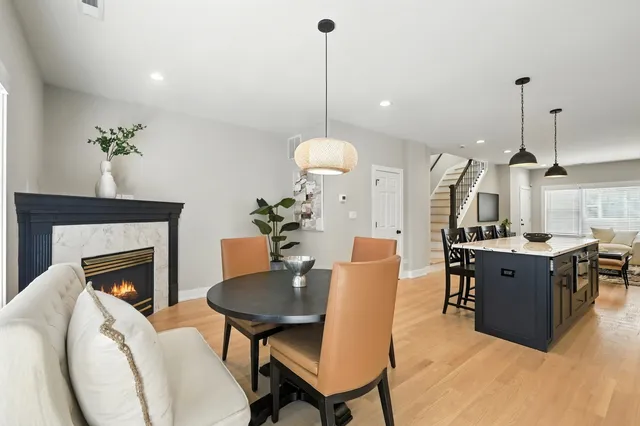 a living room with furniture a dining table and a fireplace
