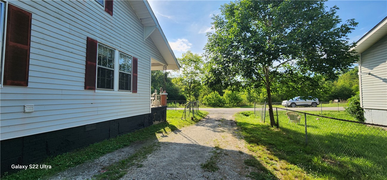 105 Hope Avenue Seneca, SC 29678 - Photo 29 of 33 Well-maintained siding and vibrant green lawn create inviting curb appeal, leading to a private entrance.