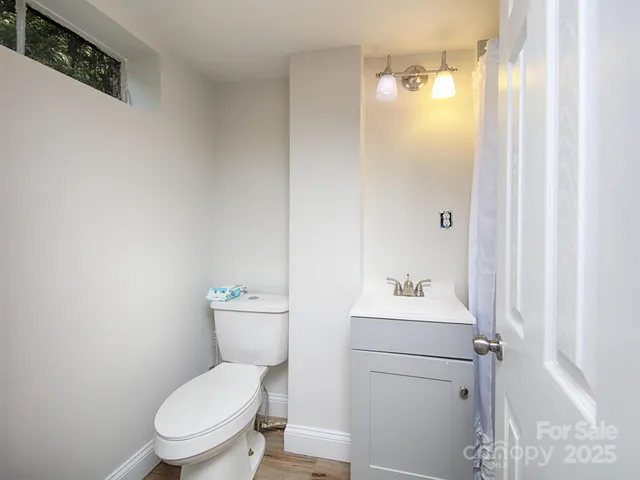 a white toilet sitting next to a bathroom sink