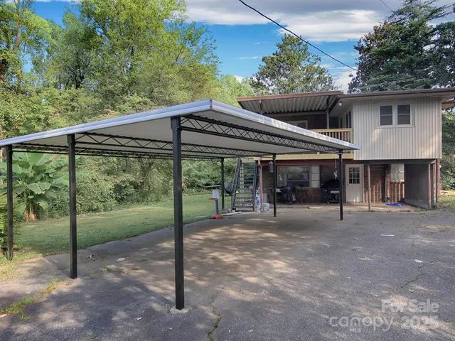 a view of a patio with a table chairs and a backyard