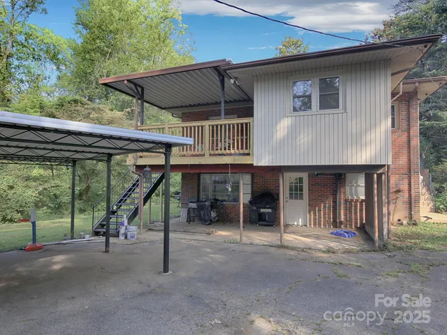 a view of a house with a flat tv screen and a floor to ceiling window
