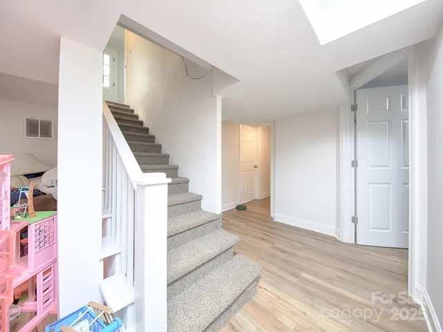 a view of entryway and hall with wooden floor