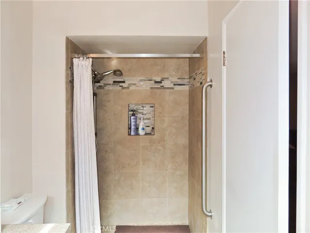 a bathroom with a granite countertop sink a large mirror and a window