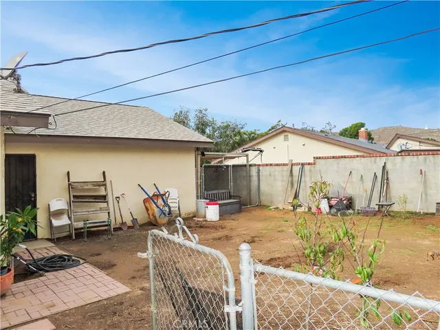 a view of a house with a yard and sitting area