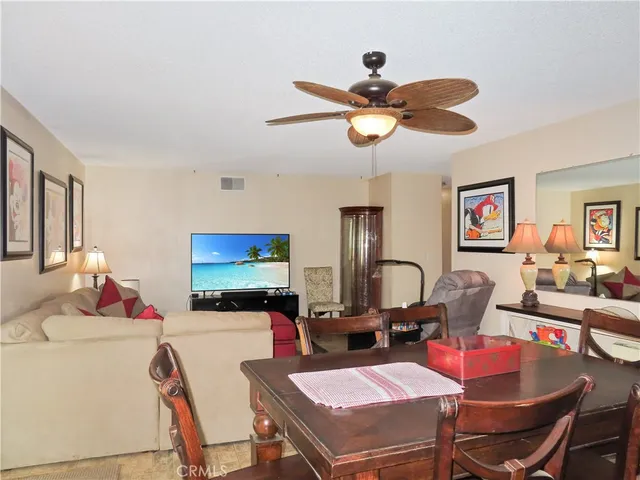 a dining room with furniture a window and a chandelier