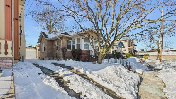 a view of a house with a yard covered in snow