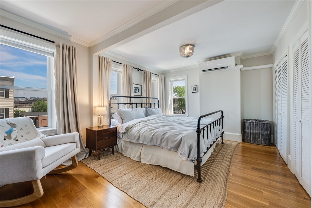 39 Emerson Street Boston, MA 02127 - Photo 12 of 20 a bedroom with a bed and a large window