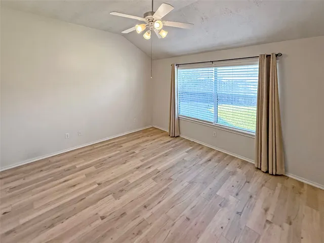 wooden floor in an empty room with a window