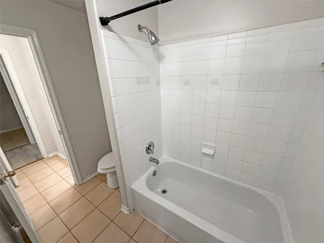 a bathroom with a bathtub and a toilet