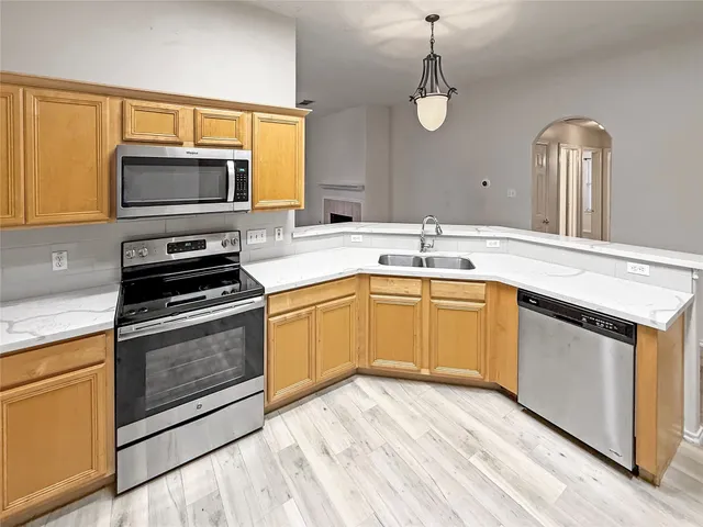 a kitchen with a sink stove and microwave