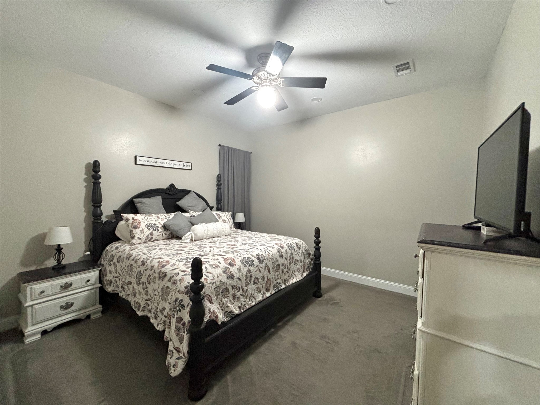 516 County Road 4800 Warren, TX 77664 - Photo 23 of 50 a bedroom with a bed and a flat tv screen on the dresser