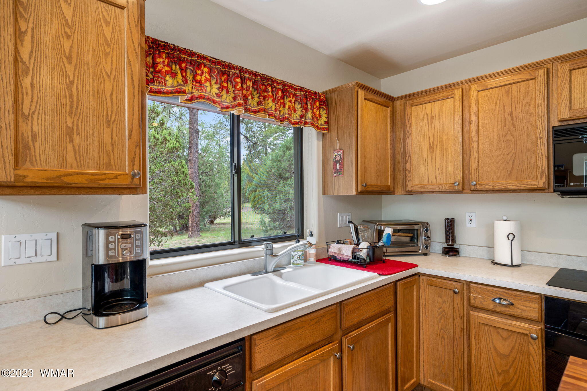 2231 Del Rio Circle Overgaard, AZ 85933 - Photo 11 of 36 a kitchen with stainless steel appliances a sink dishwasher and cabinets with wooden floor