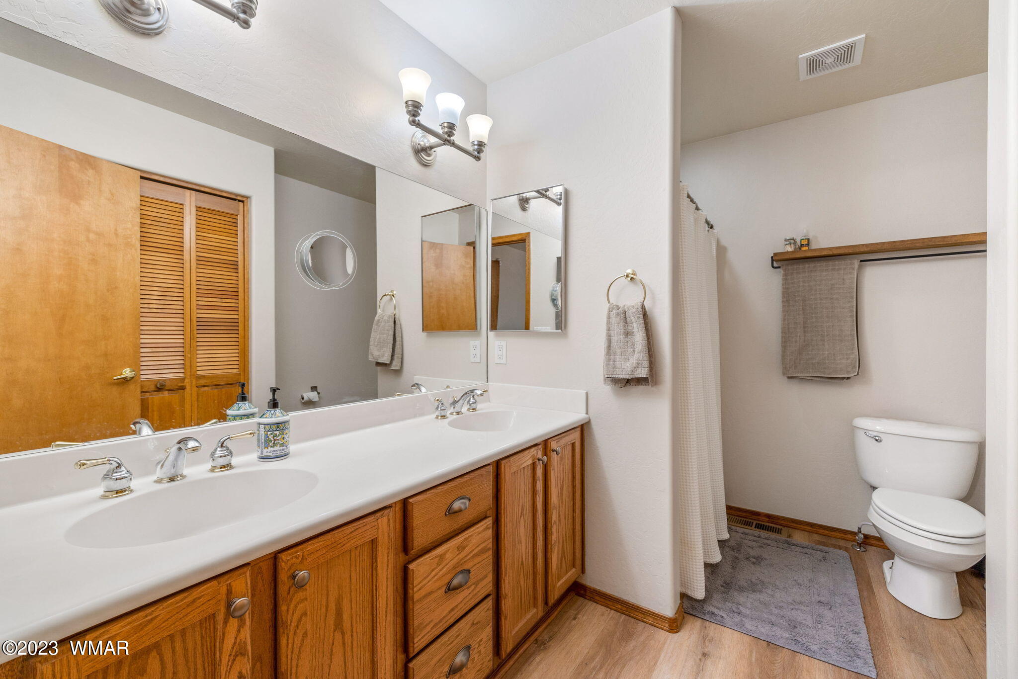 2231 Del Rio Circle Overgaard, AZ 85933 - Photo 15 of 36 a bathroom with a double vanity sink and mirror