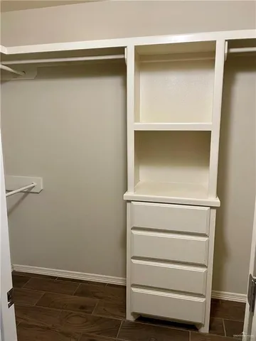 a view of walk in closet with empty racks