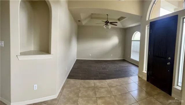 a view of a hallway with wooden floor and entryway