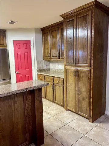 a kitchen with a refrigerator a sink and cabinets