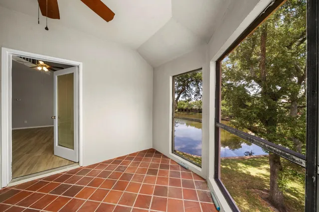 a view of an empty room and floor to ceiling window