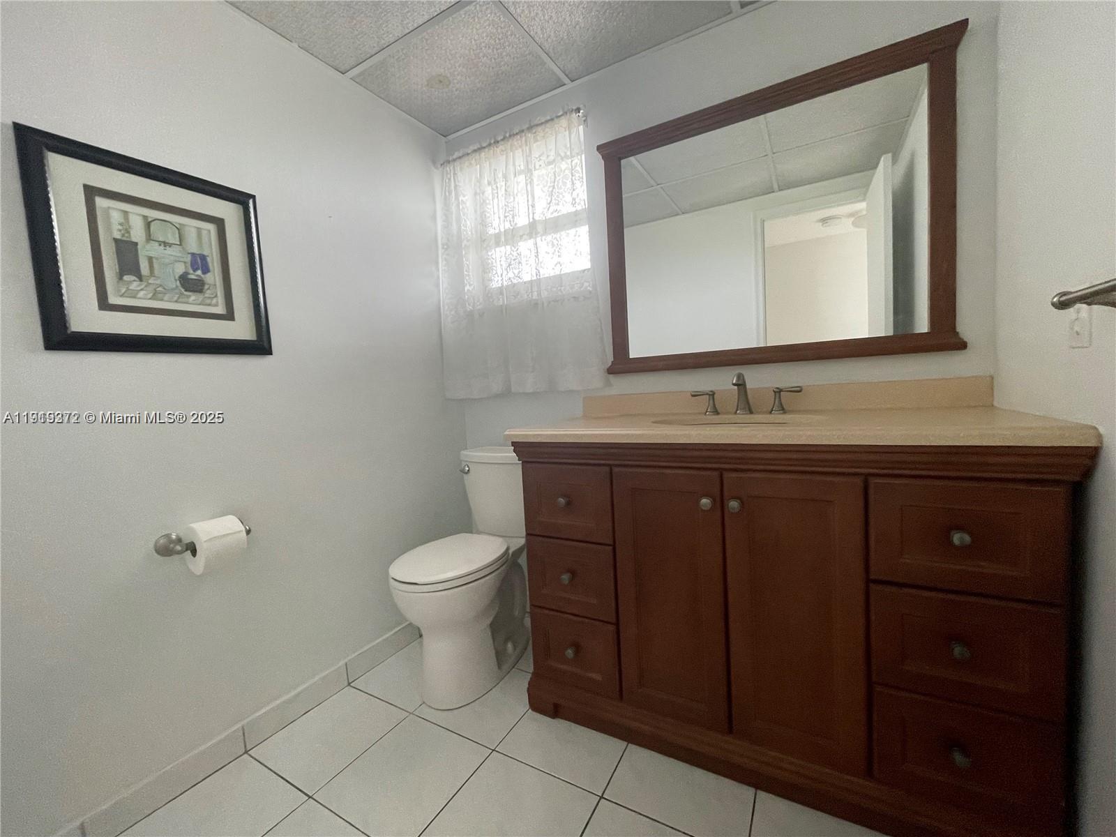 620 Northeast 12th Avenue, Unit 406 Hallandale Beach, FL 33009 - Photo 9 of 11 a bathroom with a toilet sink and mirror