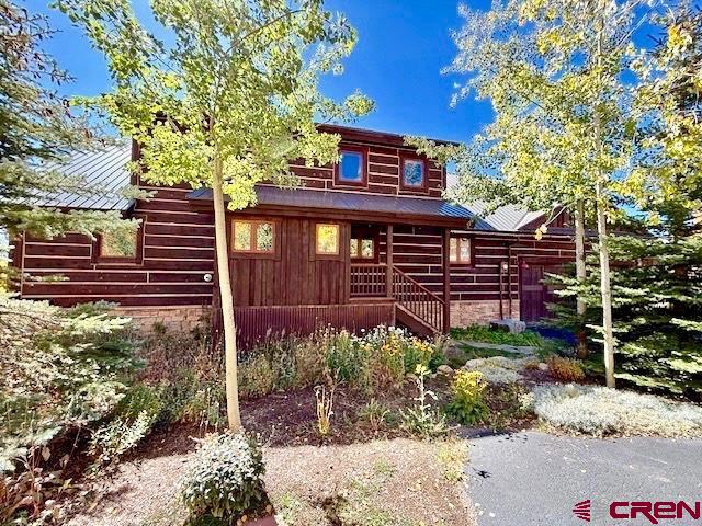 450 Meridian Lake Drive Crested Butte, CO 81224 - Photo 21 of 45 a front view of a house with garden