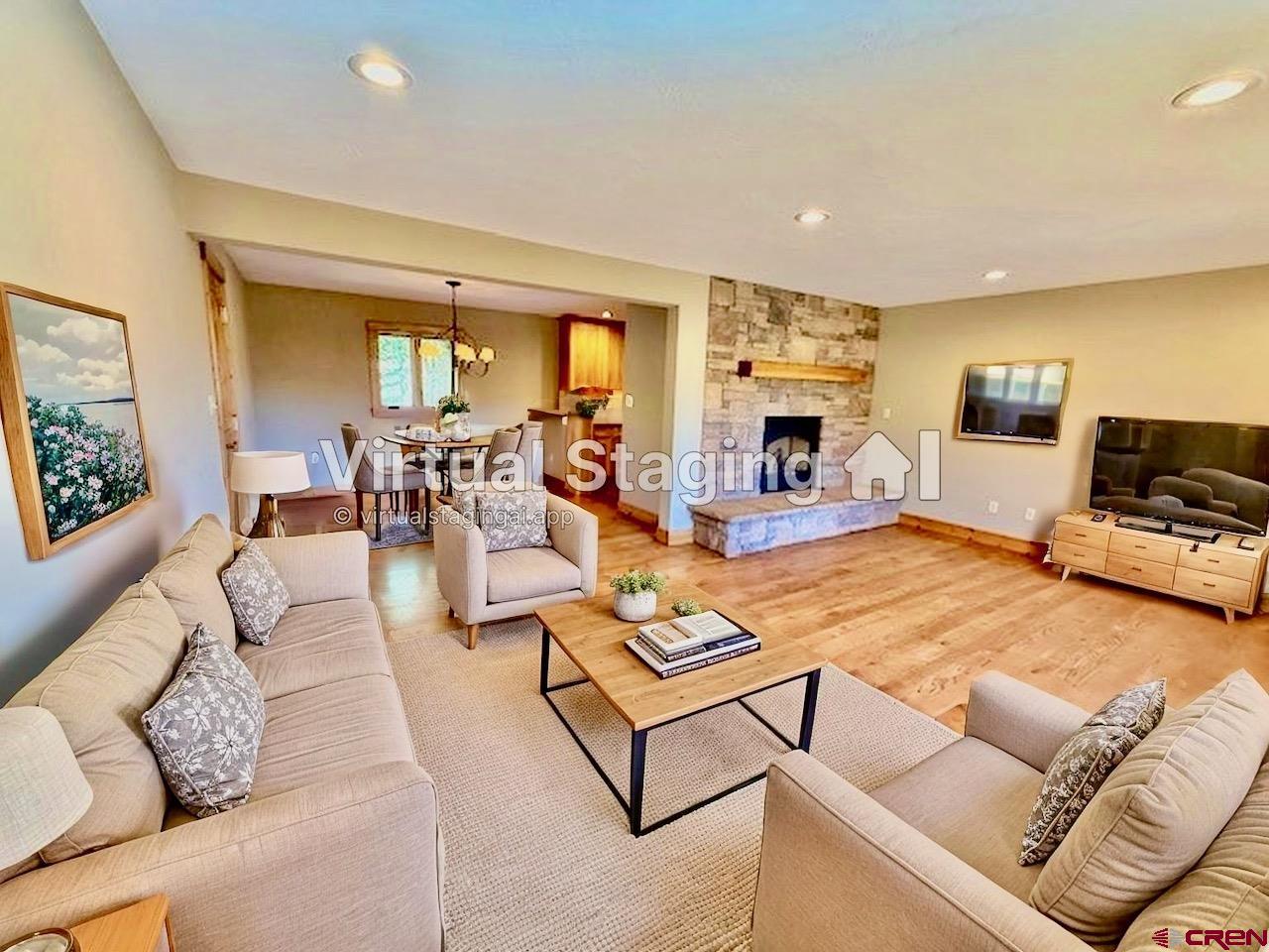 450 Meridian Lake Drive Crested Butte, CO 81224 - Photo 22 of 45 a living room with furniture flat screen tv and a fireplace