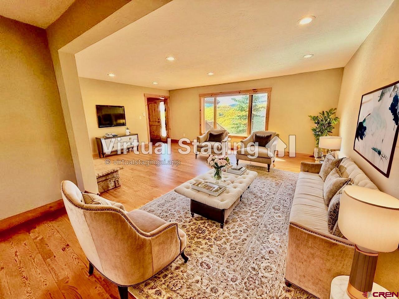 450 Meridian Lake Drive Crested Butte, CO 81224 - Photo 24 of 45 a living room with fireplace furniture and a large window