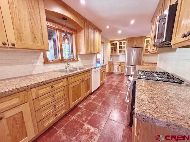450 Meridian Lake Drive Crested Butte, CO 81224 - Photo 26 of 45 a large kitchen with stainless steel appliances granite countertop a stove a sink and a microwave