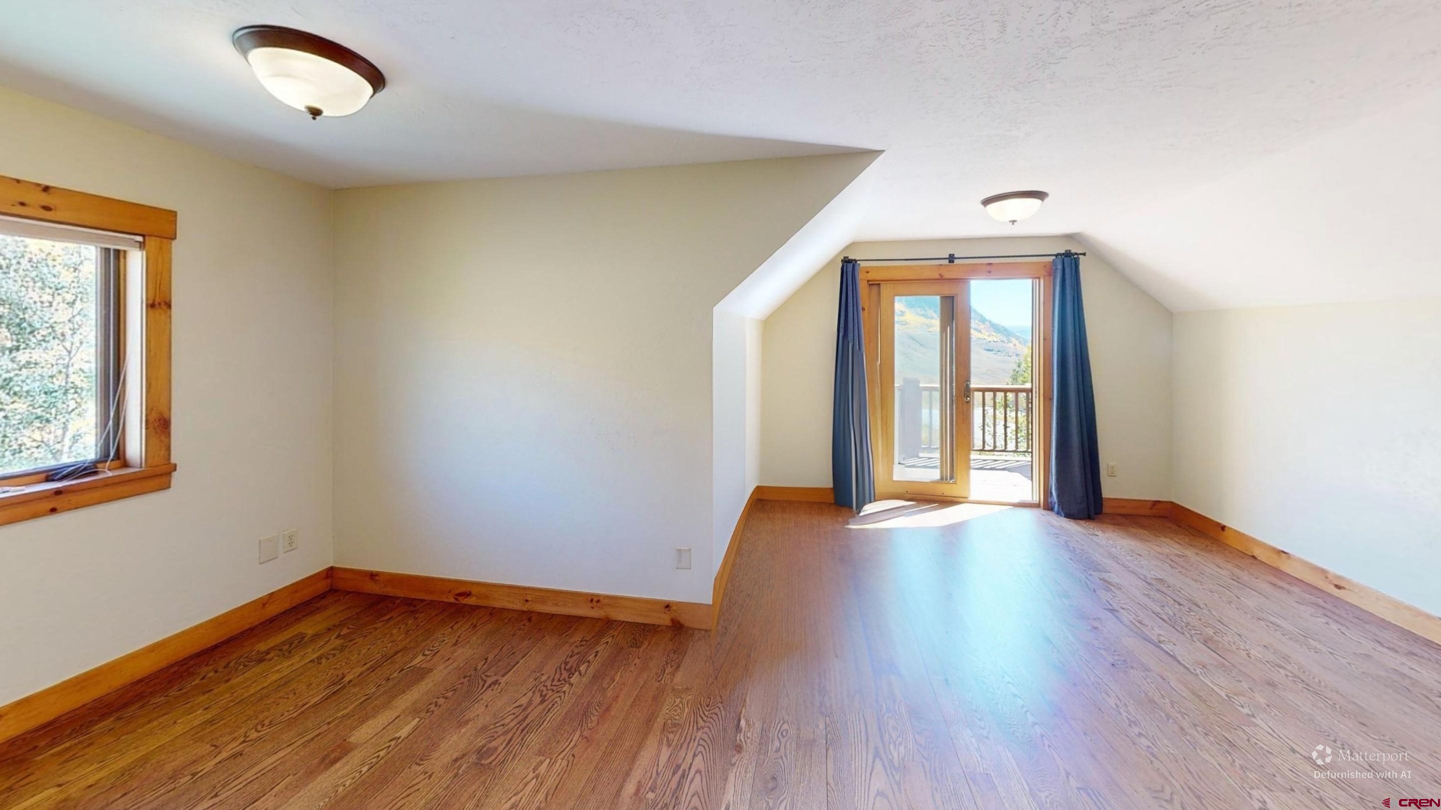 450 Meridian Lake Drive Crested Butte, CO 81224 - Photo 32 of 45 an empty room with wooden floor and windows