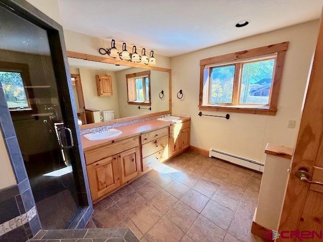 450 Meridian Lake Drive Crested Butte, CO 81224 - Photo 40 of 45 a bathroom with a sink a mirror and a bathtub