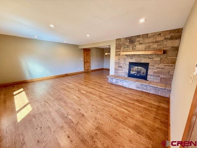 450 Meridian Lake Drive Crested Butte, CO 81224 - Photo 4 of 45 an empty room with wooden floor and fireplace