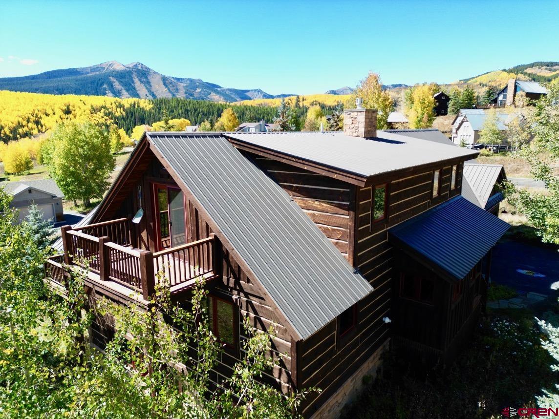 450 Meridian Lake Drive Crested Butte, CO 81224 - Photo 10 of 45 a view of a balcony with two chairs and a potted plant