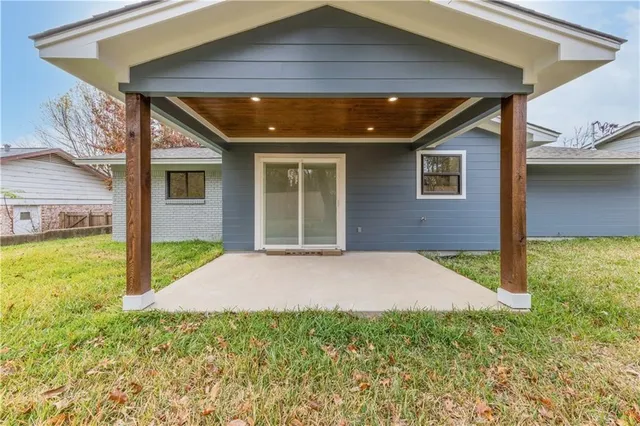 a view of yellow house with a yard