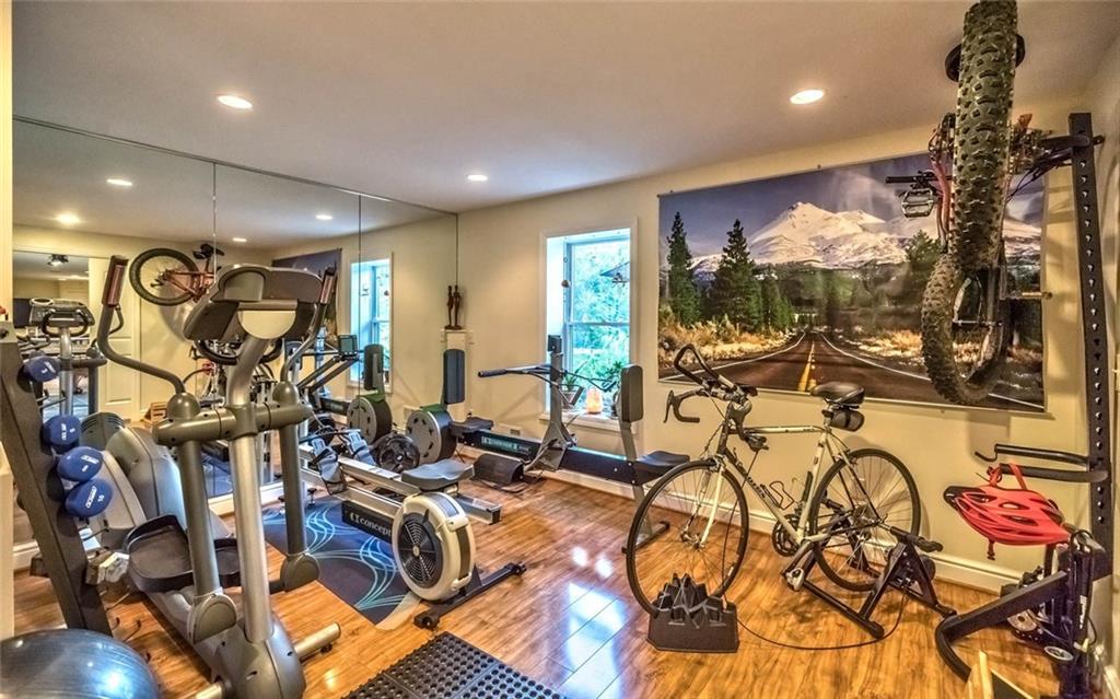 183 Davidson Road Mars, PA 16046 - Photo 13 of 25 14x14 gym on the lower level could be a 6th bedroom due to the window and closet that are currently present. There are dual pocket doors to close off the family room area, recessed lights, and laminate wood look flooring.