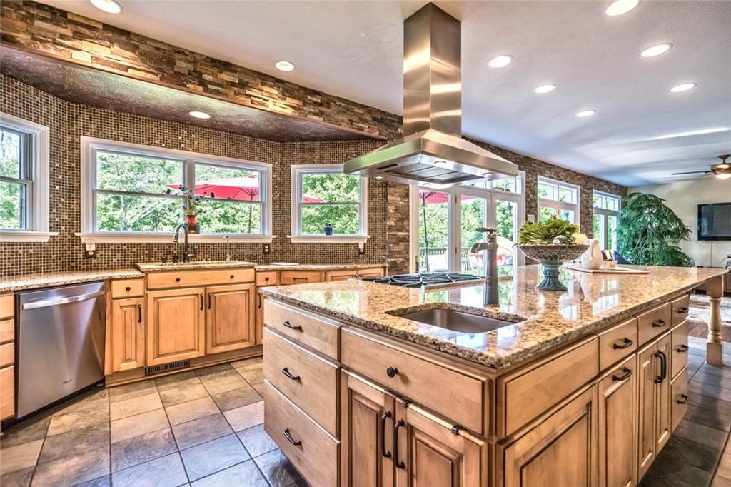 183 Davidson Road Mars, PA 16046 - Photo 5 of 25 The California stacked stone accent along the back wall and stunning backsplash shine thanks to the abundant recessed lights and natural light from the wall of windows with transom accents.