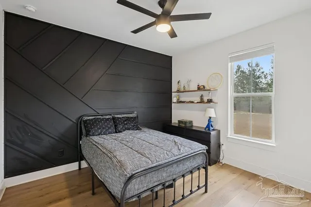 a bedroom with a bed and a chandelier