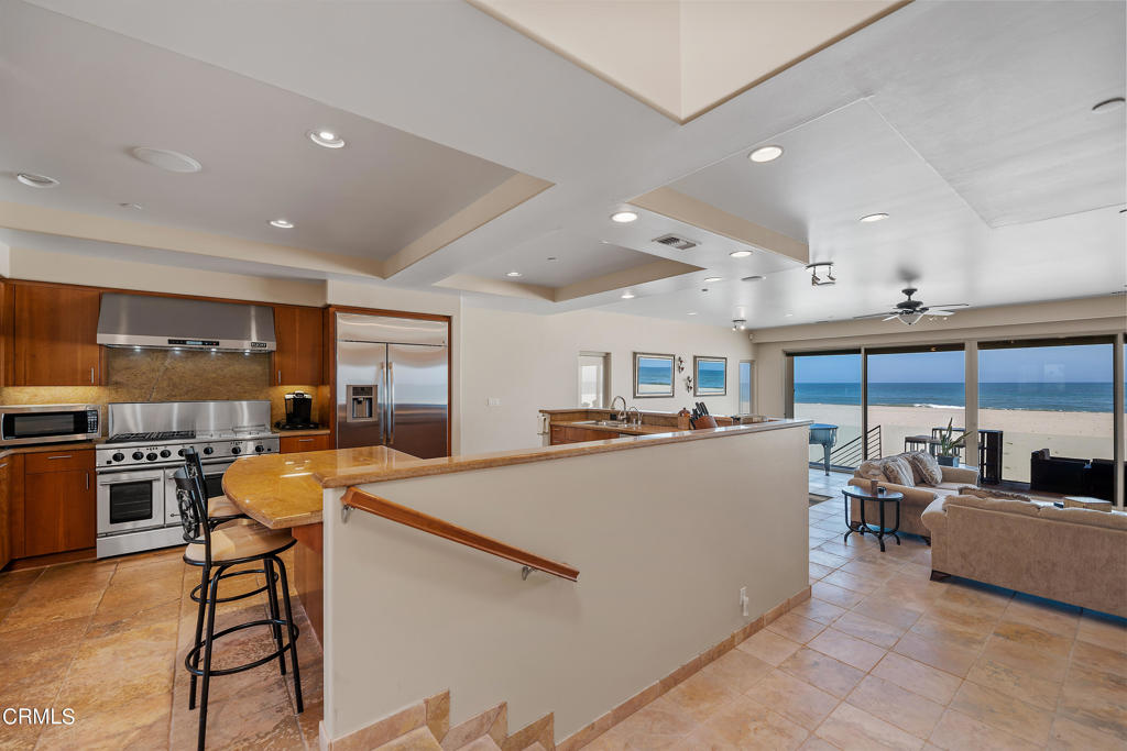 791 Mandalay Beach Road Oxnard, CA 93035 - Photo 25 of 46 a kitchen with stainless steel appliances granite countertop a refrigerator and a stove top oven with wooden floor