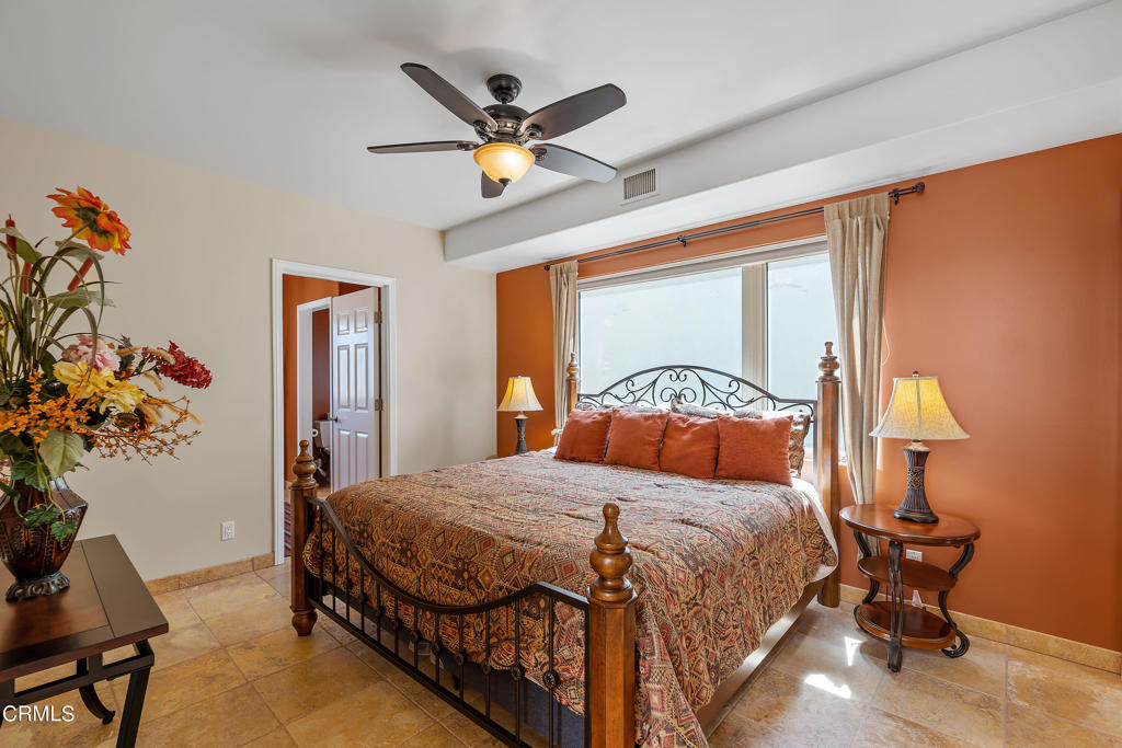791 Mandalay Beach Road Oxnard, CA 93035 - Photo 33 of 46 a bedroom with a large bed and a chandelier