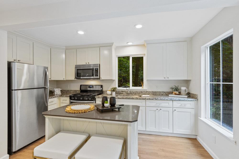 35 Park Way Mount Hermon, CA 95041 - Photo 11 of 46 a kitchen with a refrigerator a stove a sink and white cabinets with wooden floor