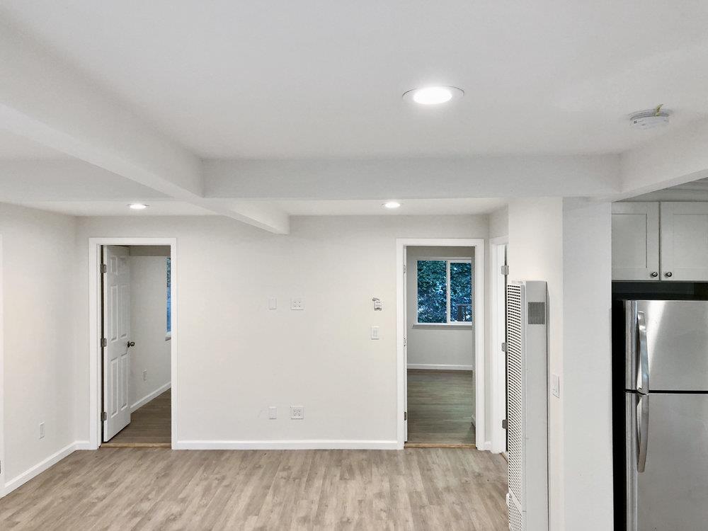 35 Park Way Mount Hermon, CA 95041 - Photo 31 of 46 a view of an empty room with wooden floor and a kitchen