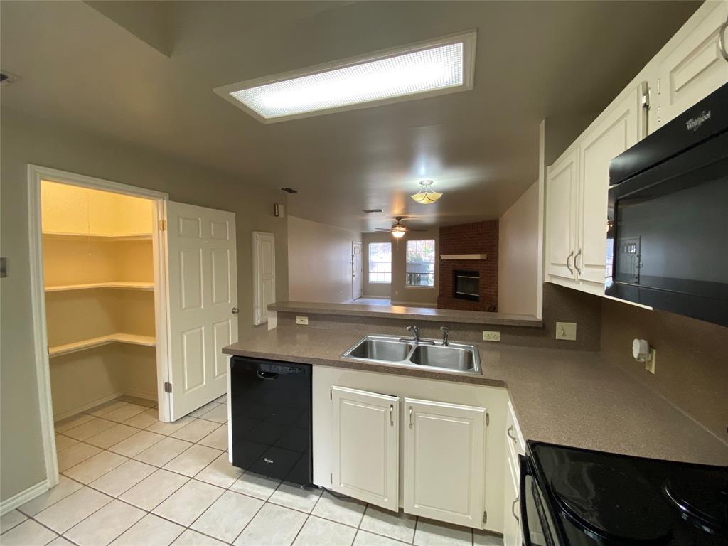 3241 Lexington Drive Tyler, TX 75701 - Photo 11 of 17 a kitchen with a sink stove and cabinets
