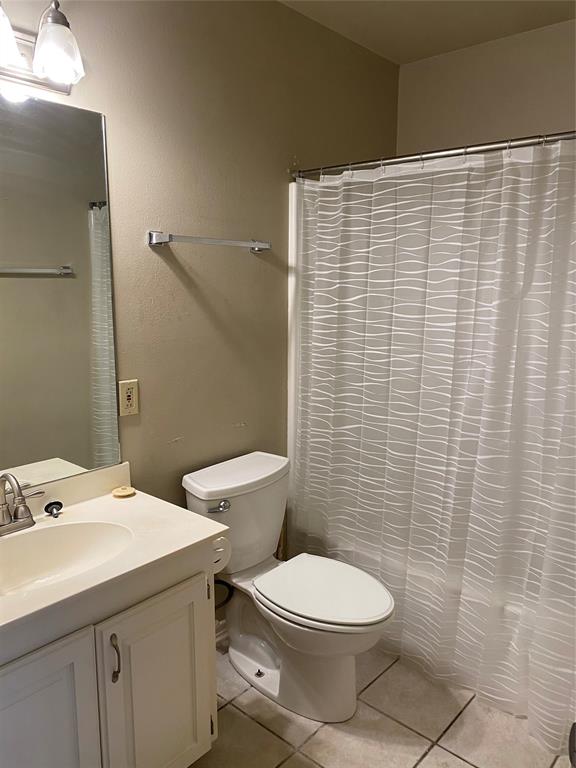 3241 Lexington Drive Tyler, TX 75701 - Photo 14 of 17 a bathroom with a toilet a sink and shower