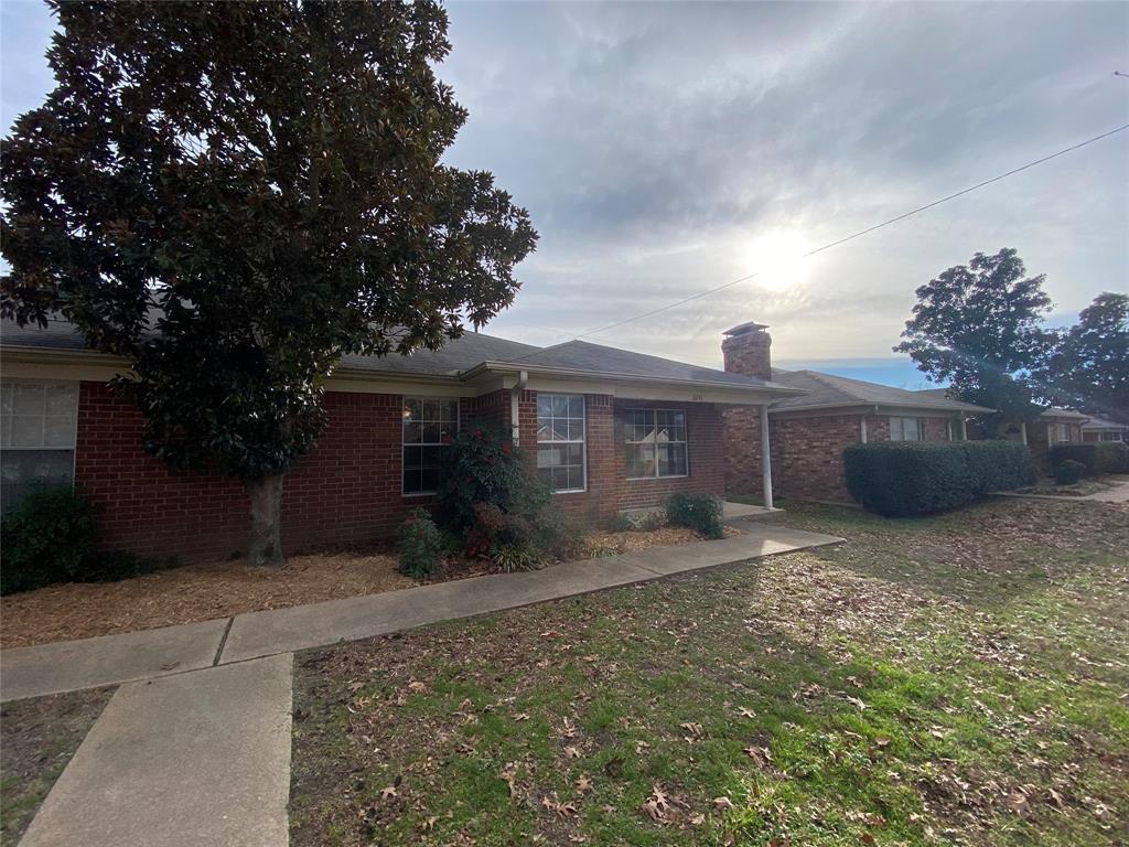 3241 Lexington Drive Tyler, TX 75701 - Photo 3 of 17 a front view of a house with a yard and garage